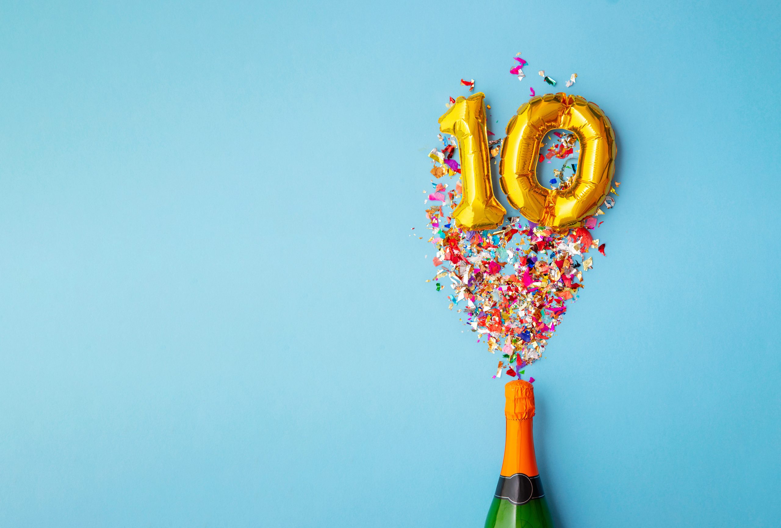 baloons in the shape of a 10 with a wine bottle and cofetti